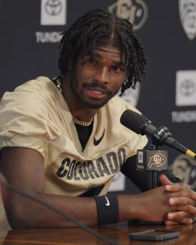 Shedeur Sanders at the podium talking to Colorado Media