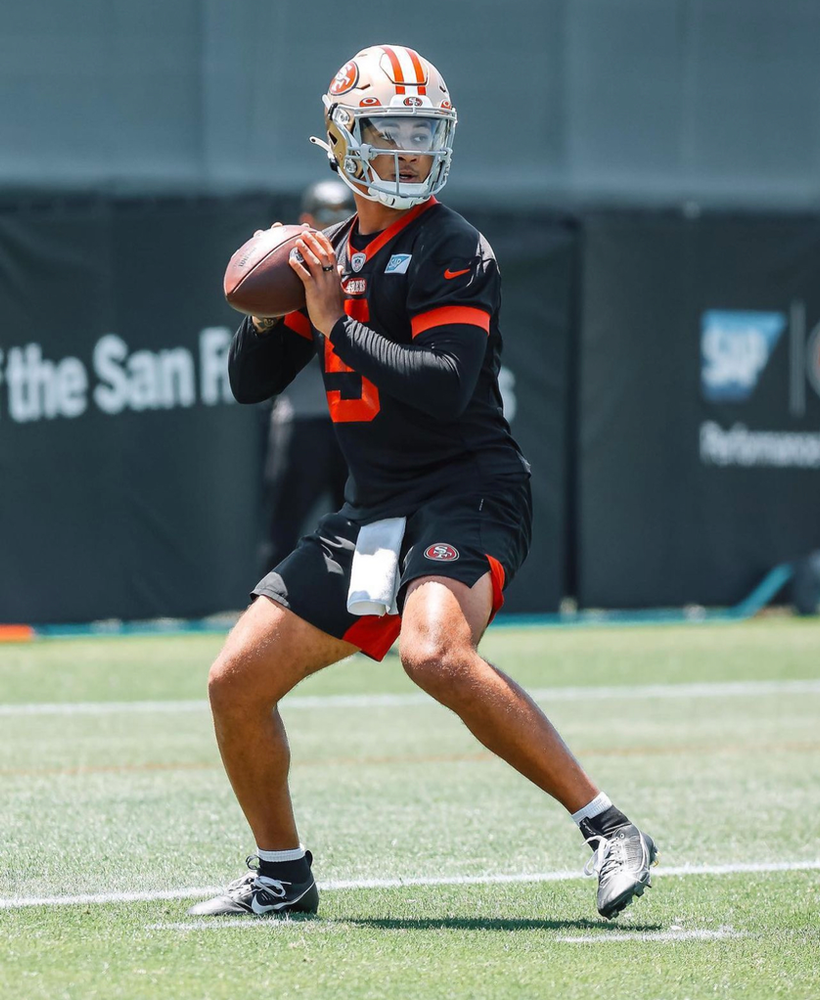 Trey Lance looks to throw the ball to his receiver 